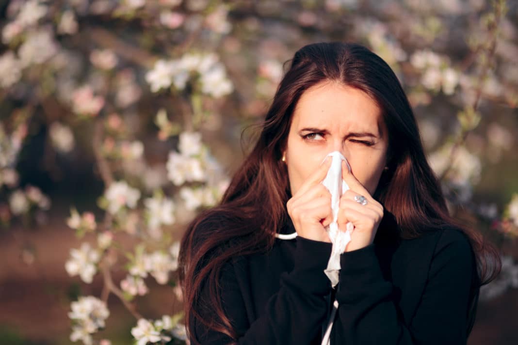 Girl Blowing Her Nose Outdoors In Spring Season